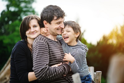 family with toddler in the woods at dawn