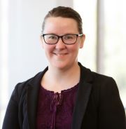 A person wearing glasses and a black jacket

AI-generated content may be incorrect.