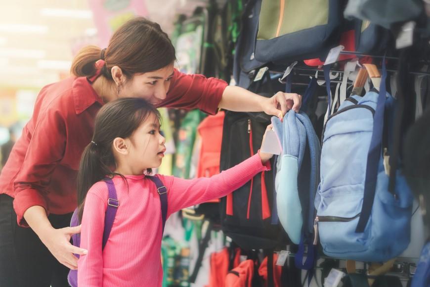 Mom and daughter buying back pack