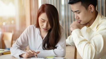 Couple using calculator